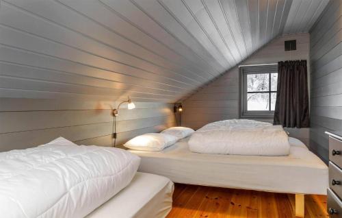 two beds in a room with a attic at Gorgeous Apartment In Hemsedal With Wifi in Hemsedal