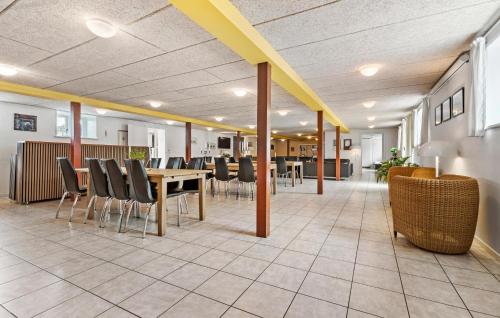 a dining room with a table and chairs at 11 Bedroom Pet Friendly Home In Rønde in Rønde