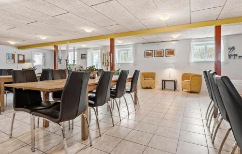 a dining room with a table and chairs at 11 Bedroom Pet Friendly Home In Rønde in Rønde