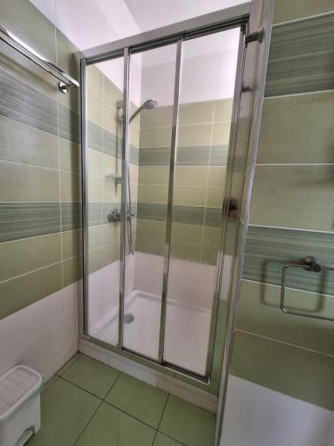 a shower with a glass door in a bathroom at Limassol sea view studio in Limassol