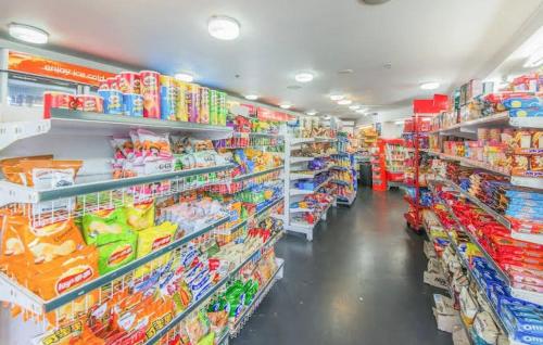 a store aisle of a grocery store with lots of products at City room in apartment near University in Auckland