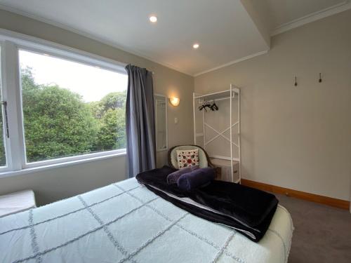a bedroom with a large window and a large bed at Wellington double bedroom in Wellington