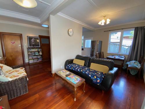 a living room with a couch and a table at Wellington double bedroom in Wellington