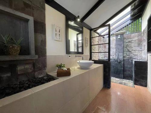 a bathroom with a sink and a fish tank at The Village Bunaken in Bunaken