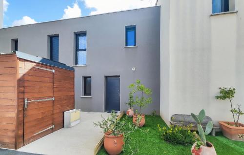 a house with a wooden gate and potted plants at 3 Bedroom Gorgeous Home In Agde in Agde