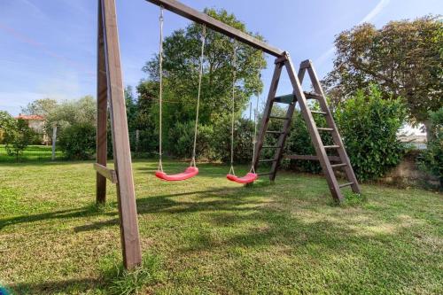 a swing set with two swings in a yard at Ferienhaus mit Privatpool für 4 Personen ca 90 qm in Šišan, Istrien Südküste von Istrien in Šišan