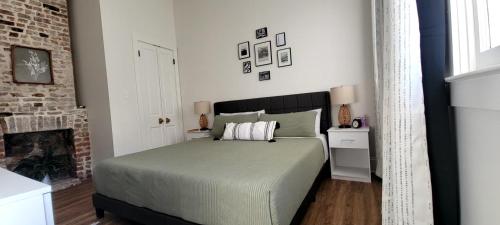 a bedroom with a large bed and a fireplace at Entire Spacious Vacation Home - Close to all City Attractions in New Orleans