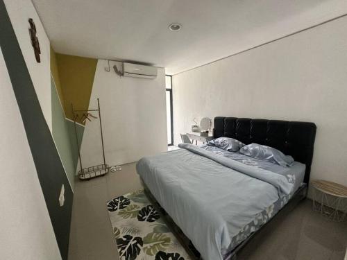 ein Schlafzimmer mit einem Bett in der Ecke eines Zimmers in der Unterkunft Cozy 3BD Home w AC & Netflix in Geutieue