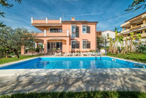 a villa with a swimming pool in front of a house at Ferienwohnung für 4 Personen ca 40 qm in Pula, Istrien Istrische Riviera - b54489 in Pula