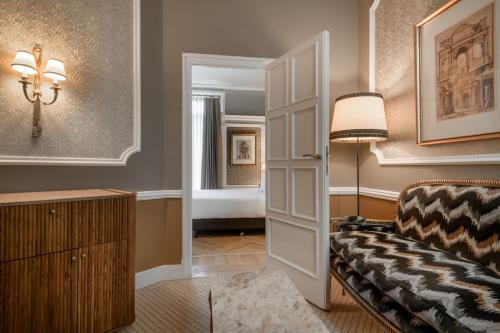 a living room with a couch and a lamp at Hotel Palacio del Retiro, Autograph Collection in Madrid