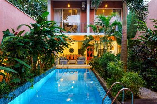 a swimming pool in the middle of a house at Angam Suites Colombo in Sri Jayewardenepura Kotte