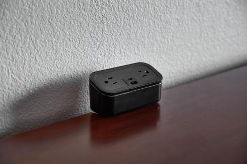 a remote control sitting on a table next to a wall at Courtyard Kansas City Overland Park/Metcalf, South of College Boulevard in Overland Park