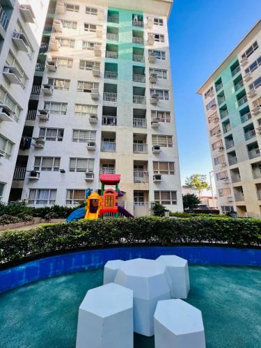 a playground in front of a large apartment building at Condo in Davao City Near Airport (Seamaster Staycation II) in Davao City