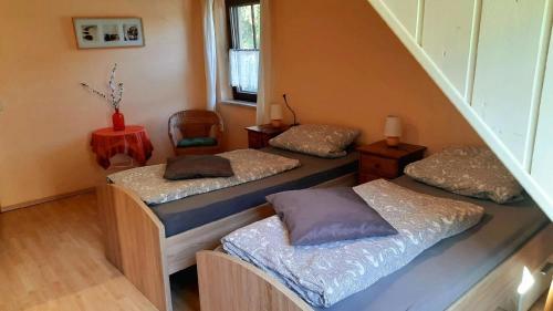 three beds in a room with a staircase at Ferienwohnung in Horben mit Großem Garten in Horben