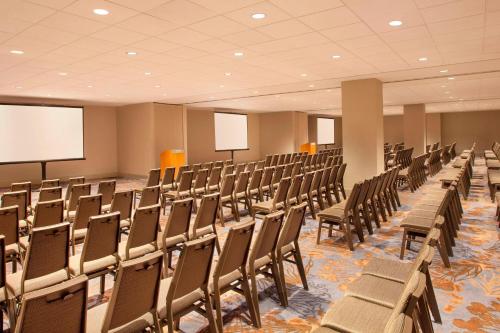 an empty conference room with chairs and a projection screen at The Westin Peachtree Plaza, Atlanta in Atlanta