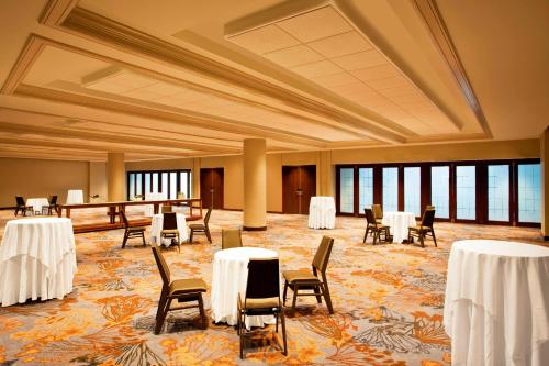 a banquet hall with white tables and chairs and windows at The Westin Peachtree Plaza, Atlanta in Atlanta