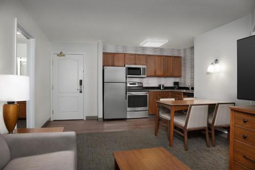a living room with a kitchen with a table at Residence Inn by Marriott San Bernardino in San Bernardino