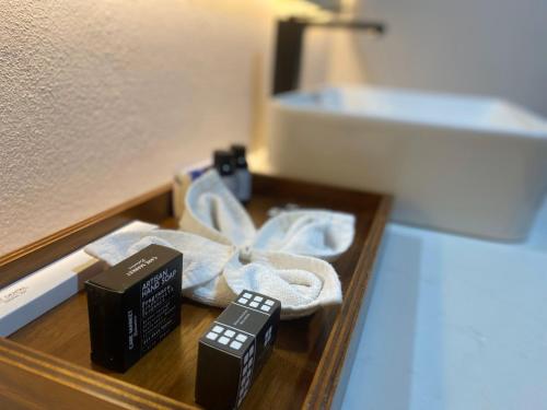 a wooden drawer with a remote control and other items at Hotel Boutique Divino Sol in León