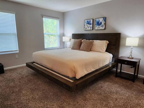a bedroom with a large bed and two lamps at Get Close to the Action! in Jacksonville