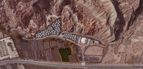 an aerial view of a building in a mountain at KaoShan Tent Zhangye in Zhangye