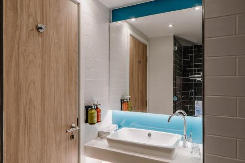 a bathroom with a sink and a mirror at Holiday Inn Express Liverpool - Central, an IHG Hotel in Liverpool