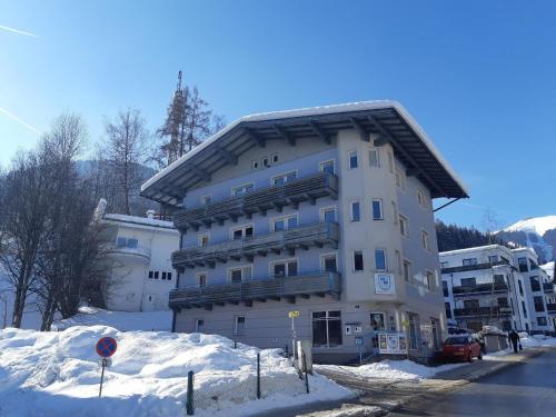 a large building with snow on the ground at Ferienwohnung für 8 Personen ca 150 qm in Zell am See, Salzburger Land Zeller See in Zell am See