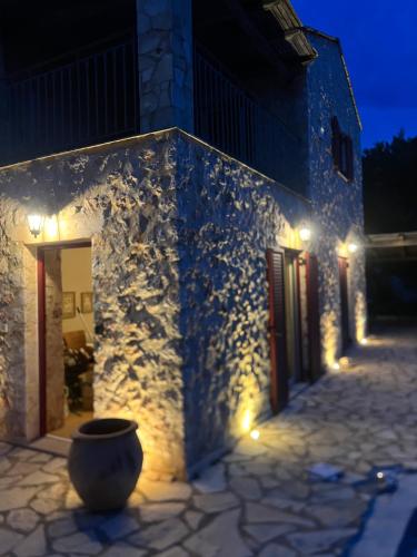 a building with lights on the side of it at night at Villa Zoe (formerly Villa Eboros) in Ratzaklíon