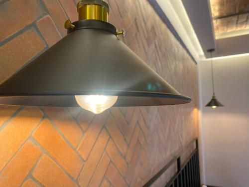 a large metal light hanging from a ceiling at Hotel Boutique Divino Sol in León