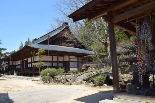 a building with a bridge in front of it at Komorebi/こもれび in Takayama