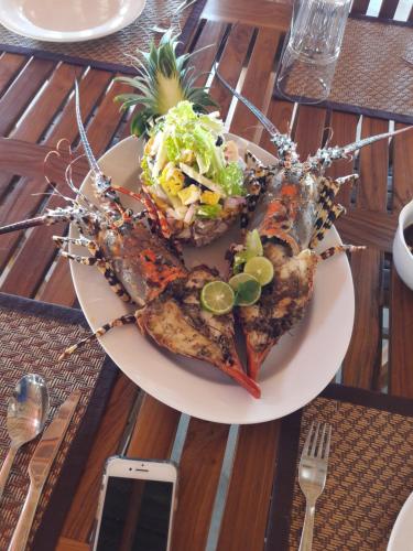 a plate of food with seafood on a table at Kitelantis Hotel and Resort in Kalpitiya