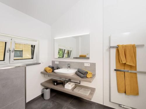 a bathroom with a sink and a mirror at STAY4 3 Modern retreat in Wunsiedel