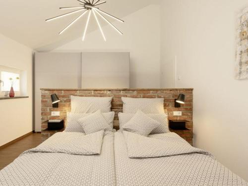 a bedroom with a large bed with white pillows at STAY4 3 Modern retreat in Wunsiedel