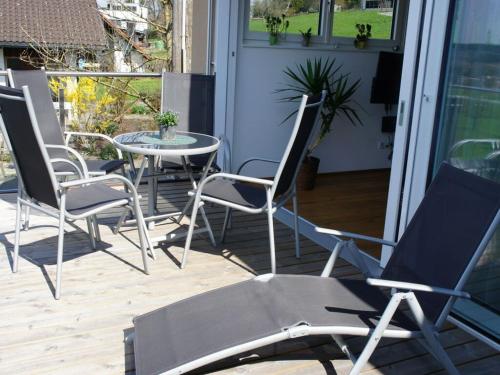 a group of chairs and a table on a porch at in the holiday home Sandra Comfortable holiday residence in Hörbranz