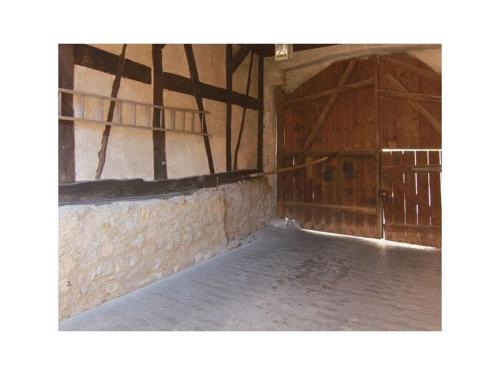 an empty room with two doors and a brick wall at Townhouse Modern Retreat in Mellrichstadt