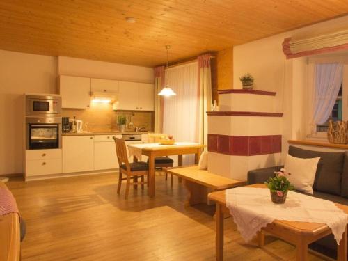 a living room with a table and a kitchen at 2 in Alpenrösle Modern retreat in Balderschwang