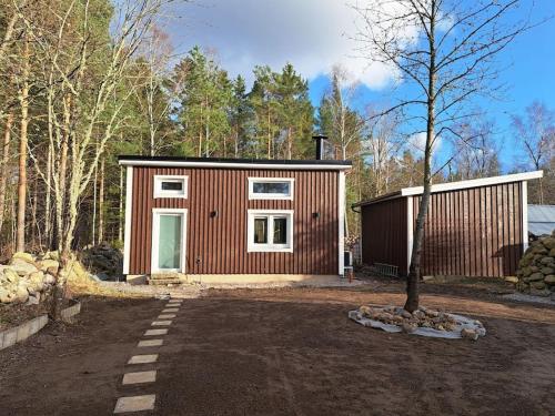 a small cabin in the middle of a forest at Attefallshus. in Västervik