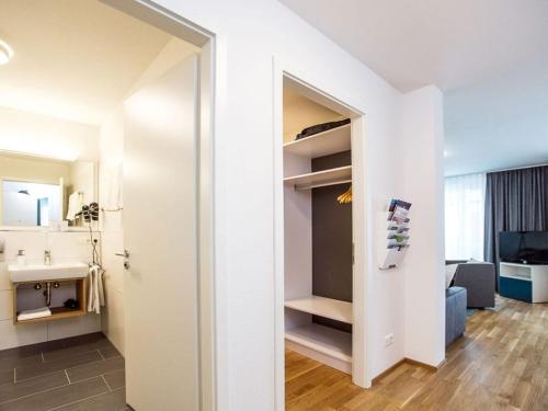 a small apartment with a closet in a room at Säntis Modern retreat in Friedrichshafen