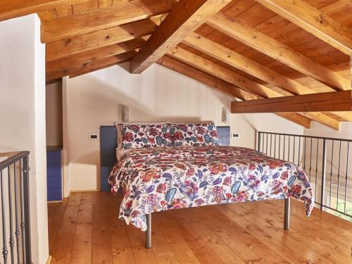 een slaapkamer met een bed in een kamer met houten plafonds bij Catenazzi 2 Modern retreat in Brezzo