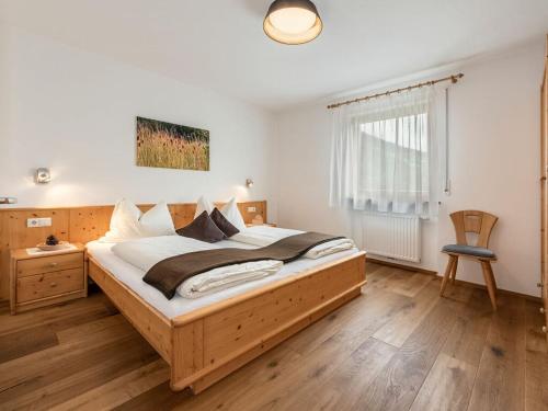 Eisackblick Modern retreat في Brixen: غرفة نوم مع سرير خشبي كبير في غرفة