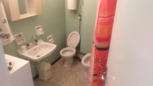 a bathroom with a toilet and a sink at Hellas Palace ROOMS LOFT in Sparti