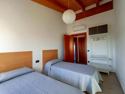 a bedroom with two beds and a ceiling at B&B Tra Gli Ulivi in Vasto