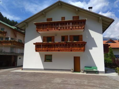 a white building with a balcony on the side at Ferienwohnung für 8 Personen ca 95 qm in Pellizzano, Trentino Val di Sole in Pellizzano