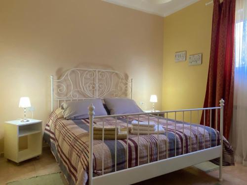 a bedroom with a bed with a metal frame at La Casa del Sole in Corvara