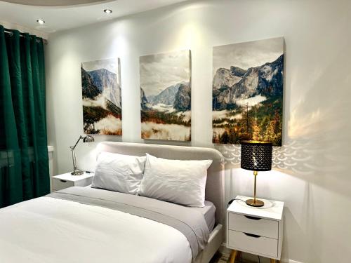 a bedroom with a bed and two paintings on the wall at One Hyde Park by Wild London in London