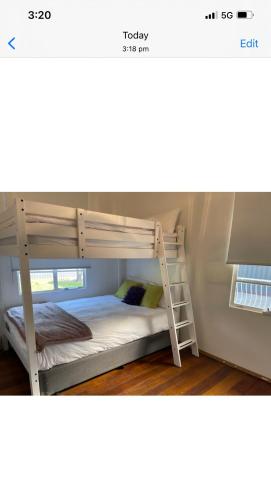 a bunk bed with a ladder in a room at D103 Lemon Tree House in Melbourne