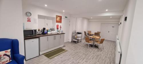 a kitchen and dining room with a table in it at The Hive Great Yarmouth in Great Yarmouth