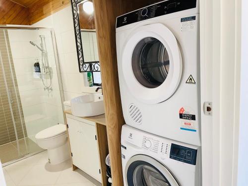 a washer and dryer in a bathroom with a toilet at D103 Lemon Tree House in Melbourne