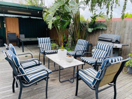 a group of chairs and a table and a grill at D103 Lemon Tree House in Melbourne