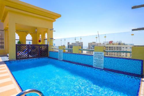 a swimming pool on the roof of a building at Palette Royal Reflections Hotel and Spa Dubai in Dubai