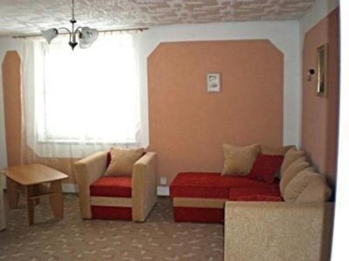 een woonkamer met een bank en een stoel bij Ferienwohnung für 8 Personen ca 80 qm in Pernink, Böhmen Skizentrum Pernink - b56697 in Pernink